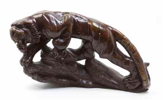 Appraisal: A Hardstone Animalier Figure depicting a stalking tiger set on