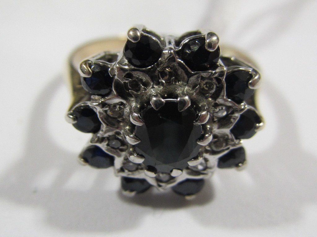 Appraisal: Bi colour gold sapphire and diamond cluster ring