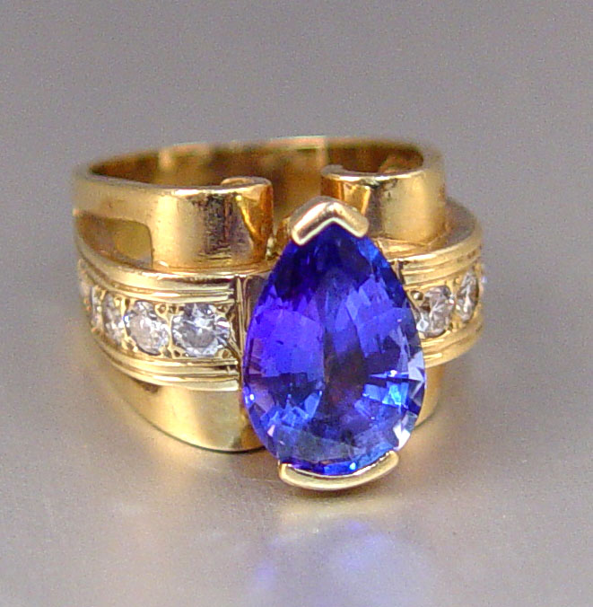 Appraisal: CT TANZANITE RING WITH DIAMONDS K yellow gold ring centering