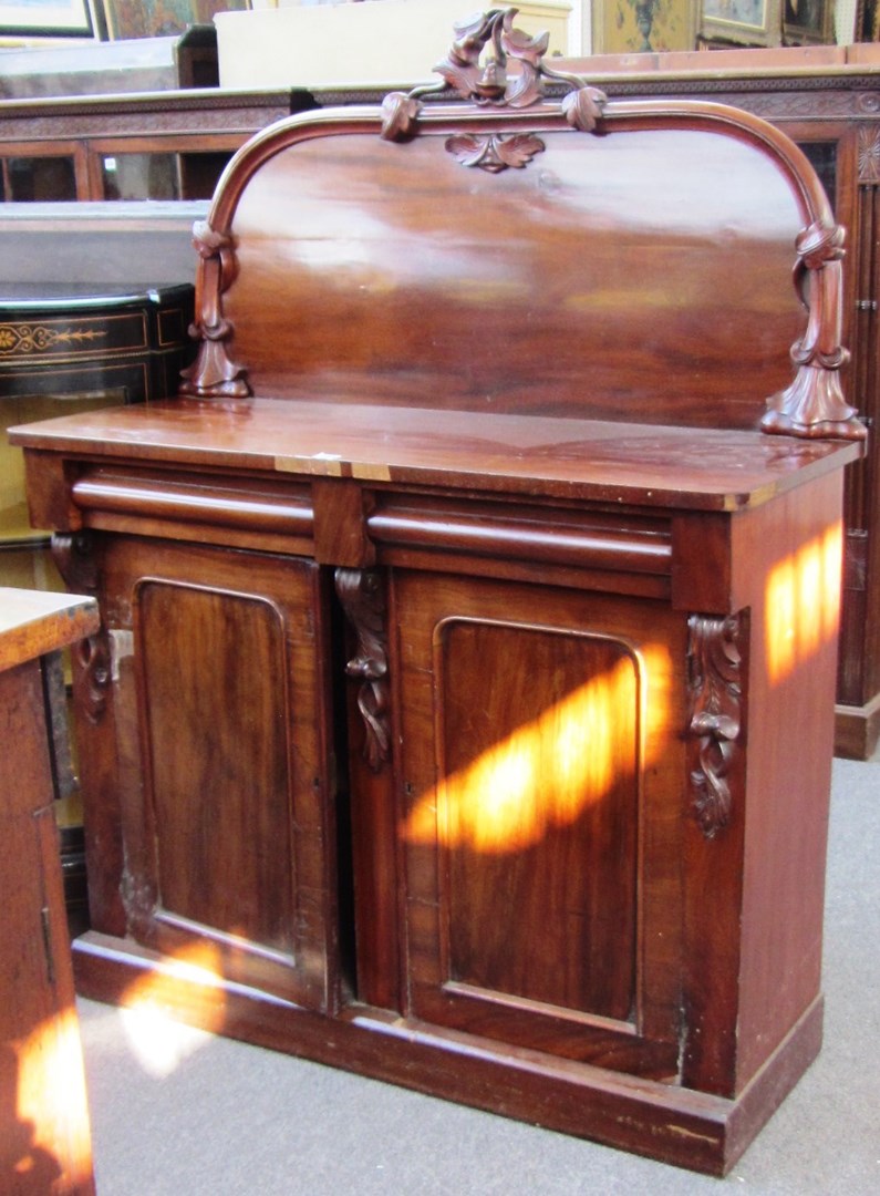 Appraisal: A Victorian mahogany carved back chiffonier with pair of drawers