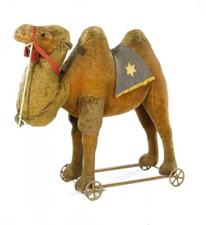 Appraisal: AN UNUSUALLY LARGE GERMAN GOLD MOHAIR PULL-ALONG CAMEL with glass