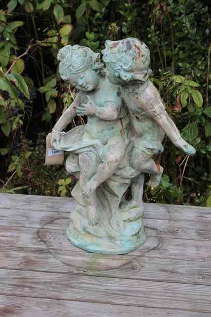 Appraisal: A BRONZED SCULPTURE of a boy and a girl playing