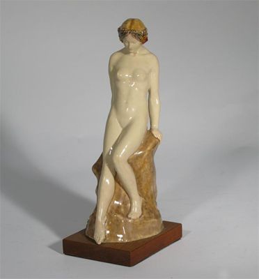 Appraisal: A pottery figure of a maiden resting on a rock