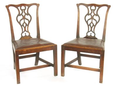 Appraisal: A pair of George III fruitwood side chairs with pierced