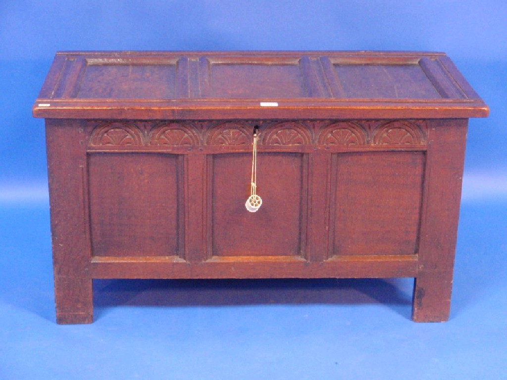 Appraisal: An thC oak coffer with triple panelled hinged lid and