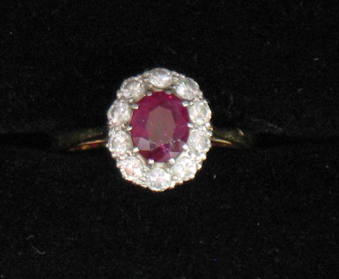 Appraisal: A RUBY AND DIAMOND CLUSTER RING the central oval cushion-cut