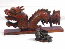 Appraisal: A carved wooden dragon and a small metal dragon incense