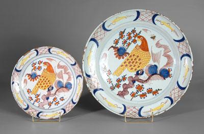 Appraisal: Two Delft bowls one with yellow and orange parrot perched