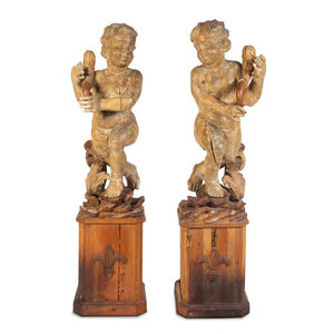 Appraisal: A Pair of Florentine Carved Walnut Figures of Putti on