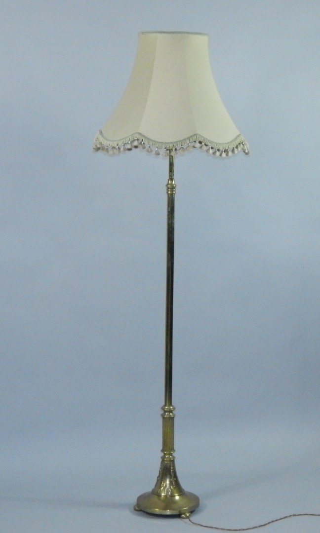 Appraisal: An Edwardian brass standard lamp plain column semi fluted at