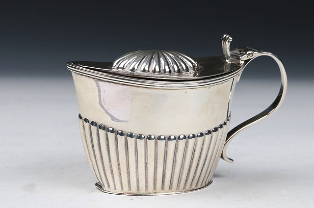 Appraisal: A GEORGE V SILVER MUSTARD POT oval shaped with fluted