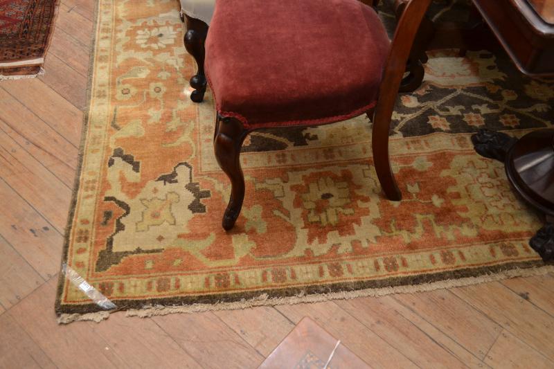 Appraisal: A LARGE WOOLEN PILE RUG IN BROWN ORANGE AND RUST