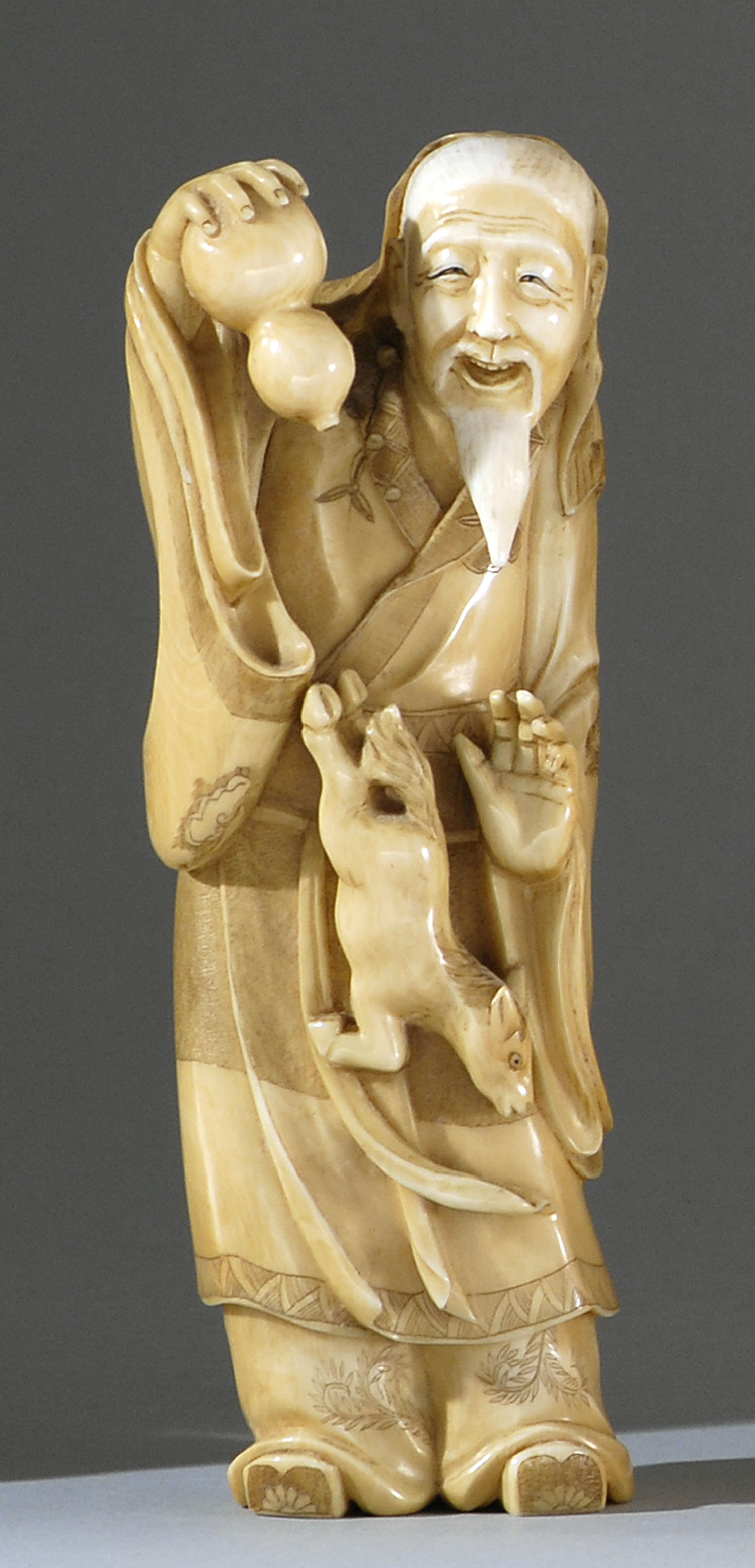 Appraisal: STAINED IVORY FIGURE Early th CenturyDepicting Chokwaro releasing a horse