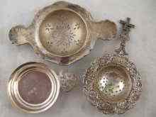 Appraisal: A mixed lot comprising two tea strainers in white metal