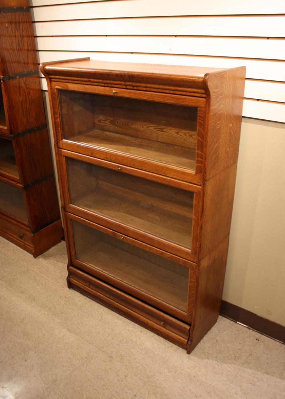 Appraisal: STACKING OAK BOOKCASE American early th century having three horizontal