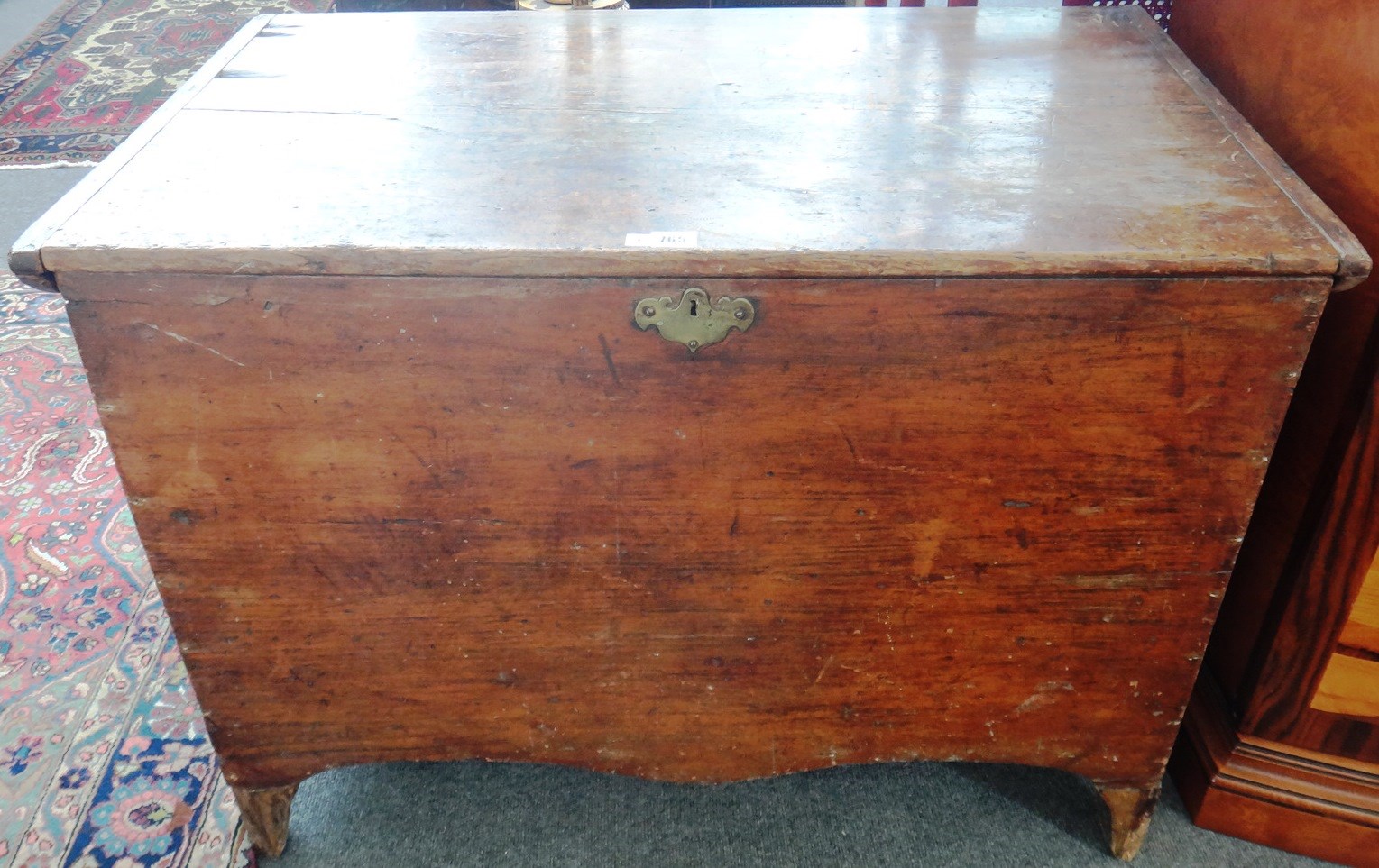 Appraisal: A late George III pine trunk with shaped apron on