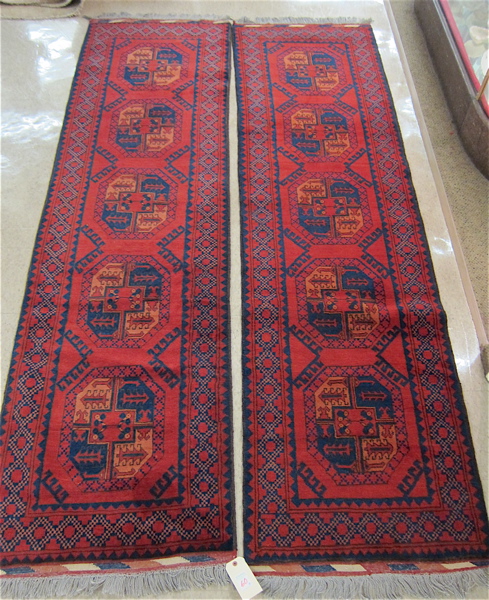 Appraisal: MATCHING PAIR OF HAND KNOTTED ORIENTAL HALL RUGS Afghan Ersari