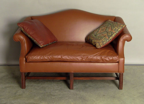 Appraisal: Chippendale style sofa with brown leather upholstery Provenance Collection of