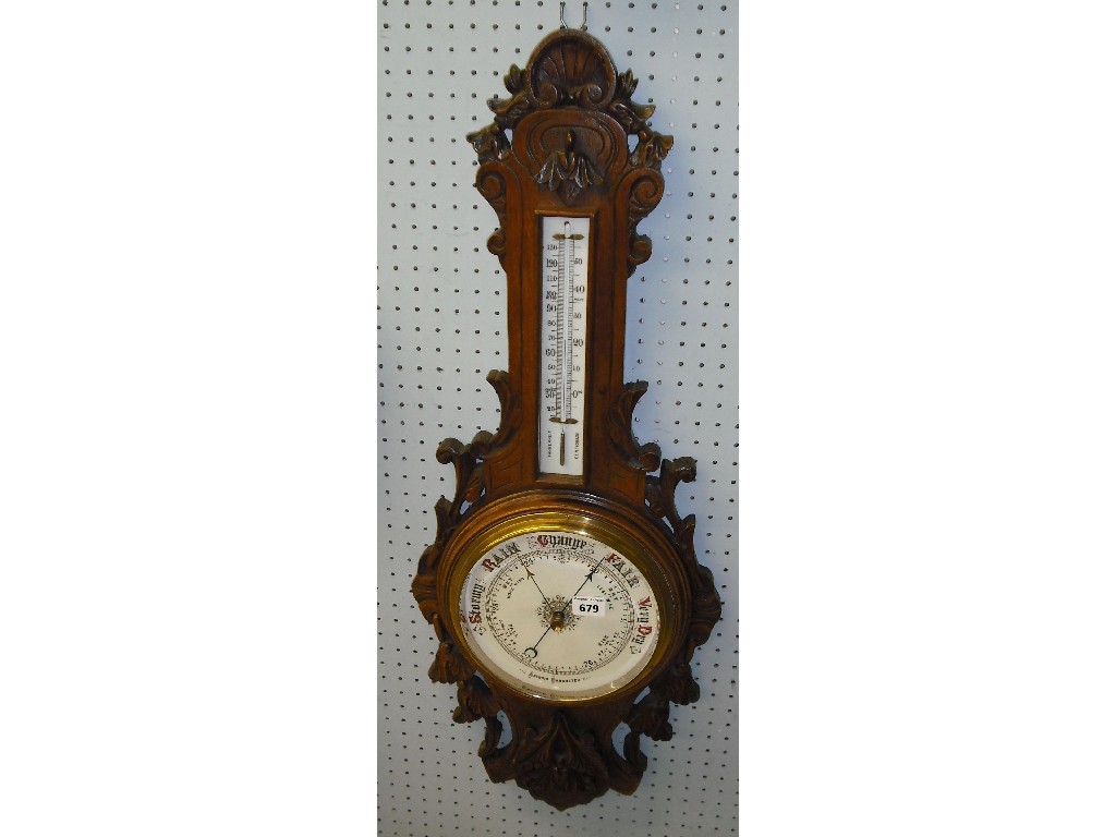 Appraisal: Oak aneroid barometer thermometer within a case pierced and carved