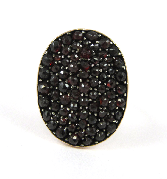 Appraisal: GARNET AND FOURTEEN KARAT GOLD RING set with an oval