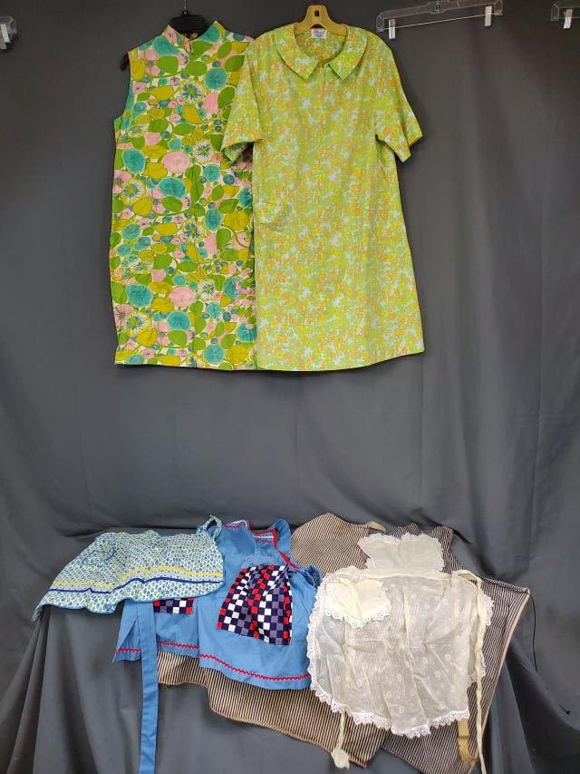 Appraisal: Includes two full aprons made of ticking a green floral