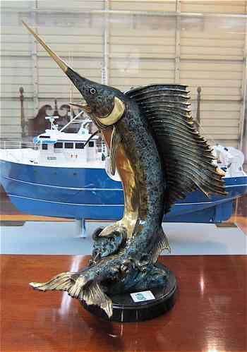 Appraisal: MARINE BRONZE SCULPTURE a sailfish in jumping pose over circular