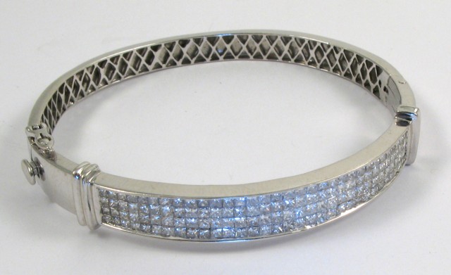 Appraisal: DIAMOND AND FOURTEEN KARAT GOLD BANGLE The top half of