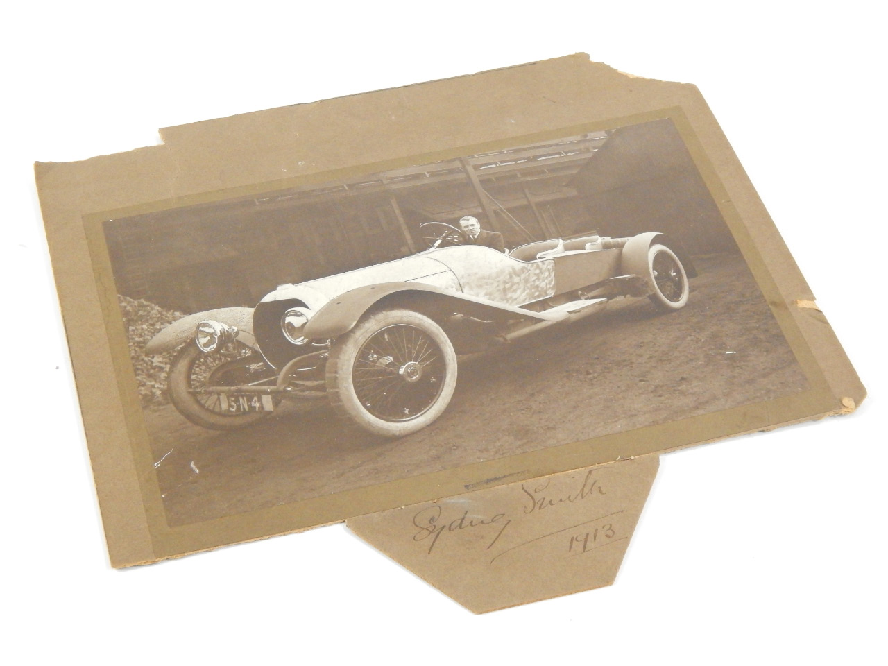 Appraisal: A period photograph of an early open tourer automobile signed