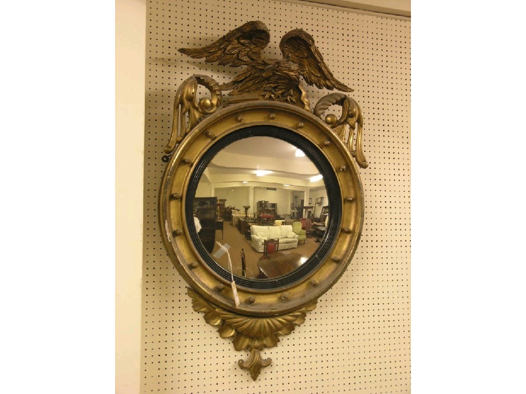 Appraisal: A large Victorian gilt convex mirror circular frame surmounted by