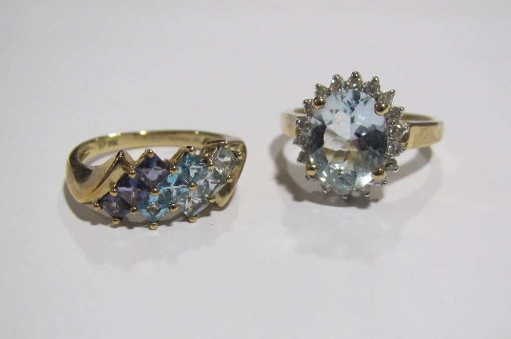 Appraisal: Nine carat gold aquamarine and diamond cluster ring and a