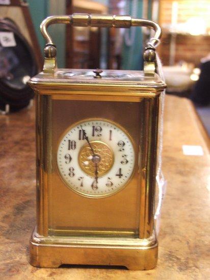 Appraisal: A FRENCH BRASS REPEATER CARRIAGE CLOCK circular white enamel dial