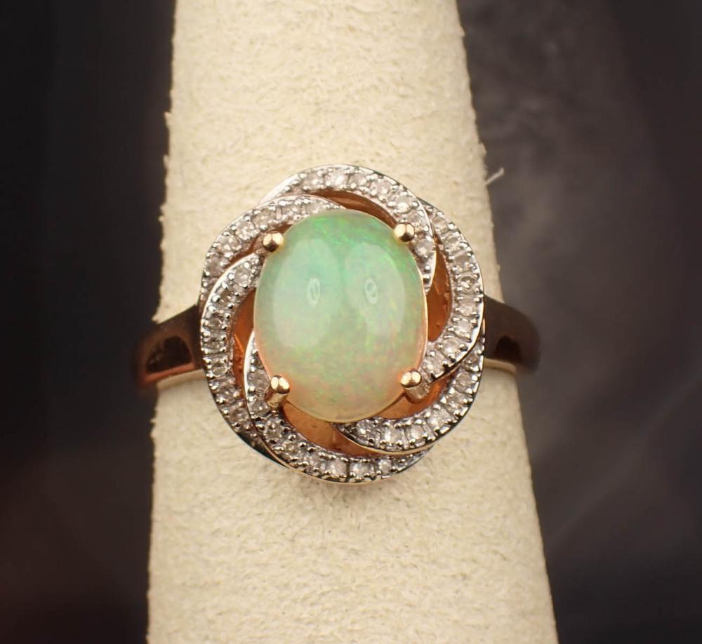 Appraisal: OPAL DIAMOND AND FOURTEEN KARAT GOLD RING The white and