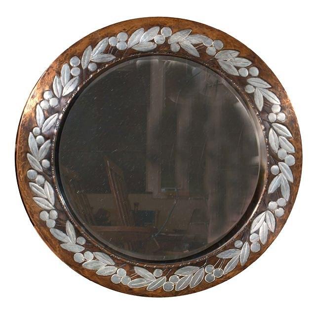 Appraisal: A 'HUGH WALLIS' COPPER AND PEWTER INLAID CIRCULAR WALL MIRROR