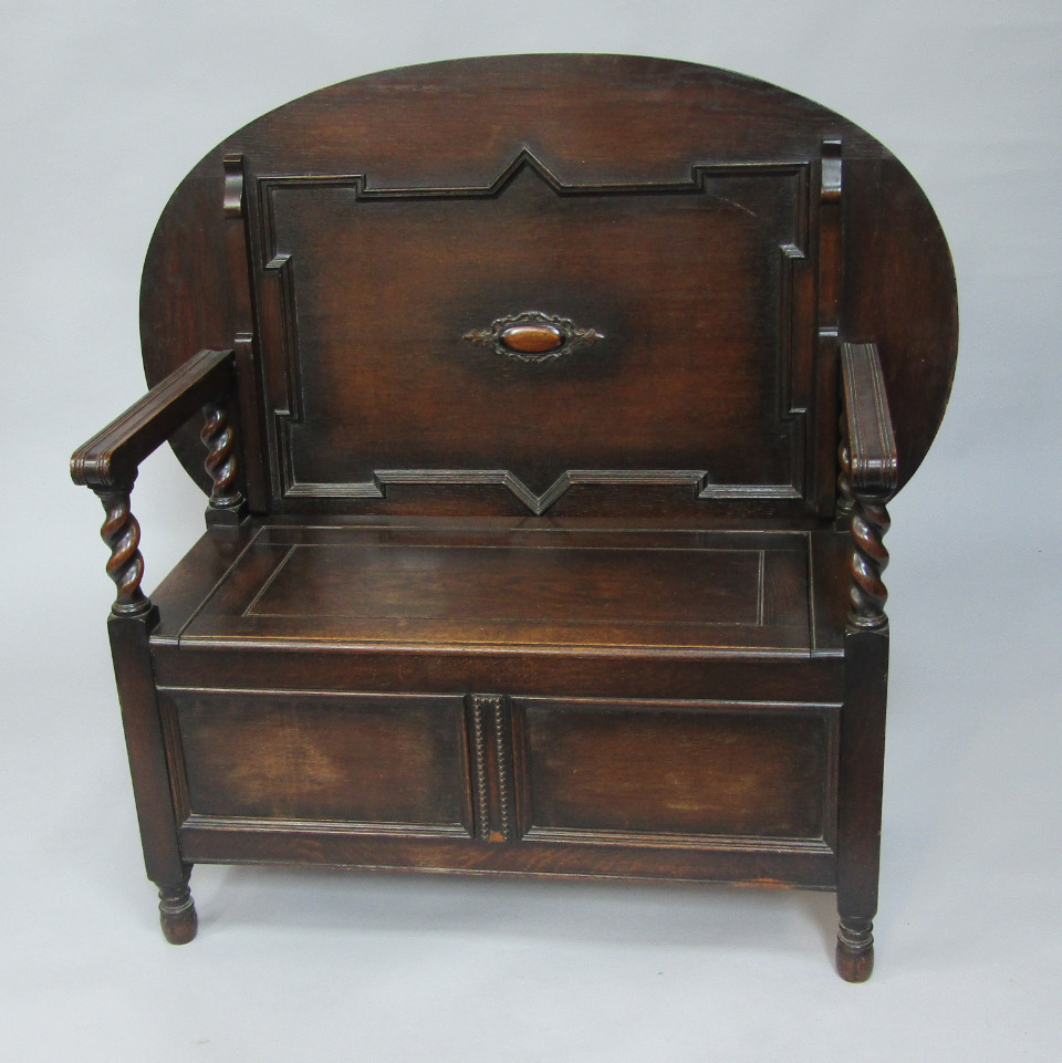 Appraisal: An oak monk's bench the oval tilt top over channeled