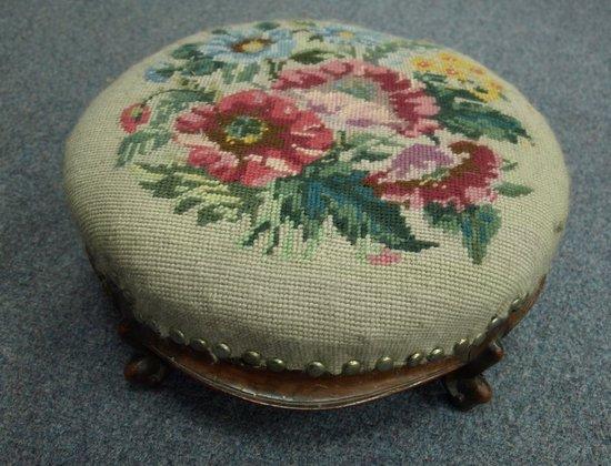 Appraisal: A Victorian walnut footstool the woolwork seat on knurl feet