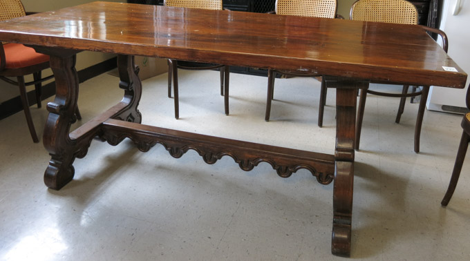 Appraisal: SPANISH COLONIAL STYLE TRESTLE-BASE DINING TABLE th century having a