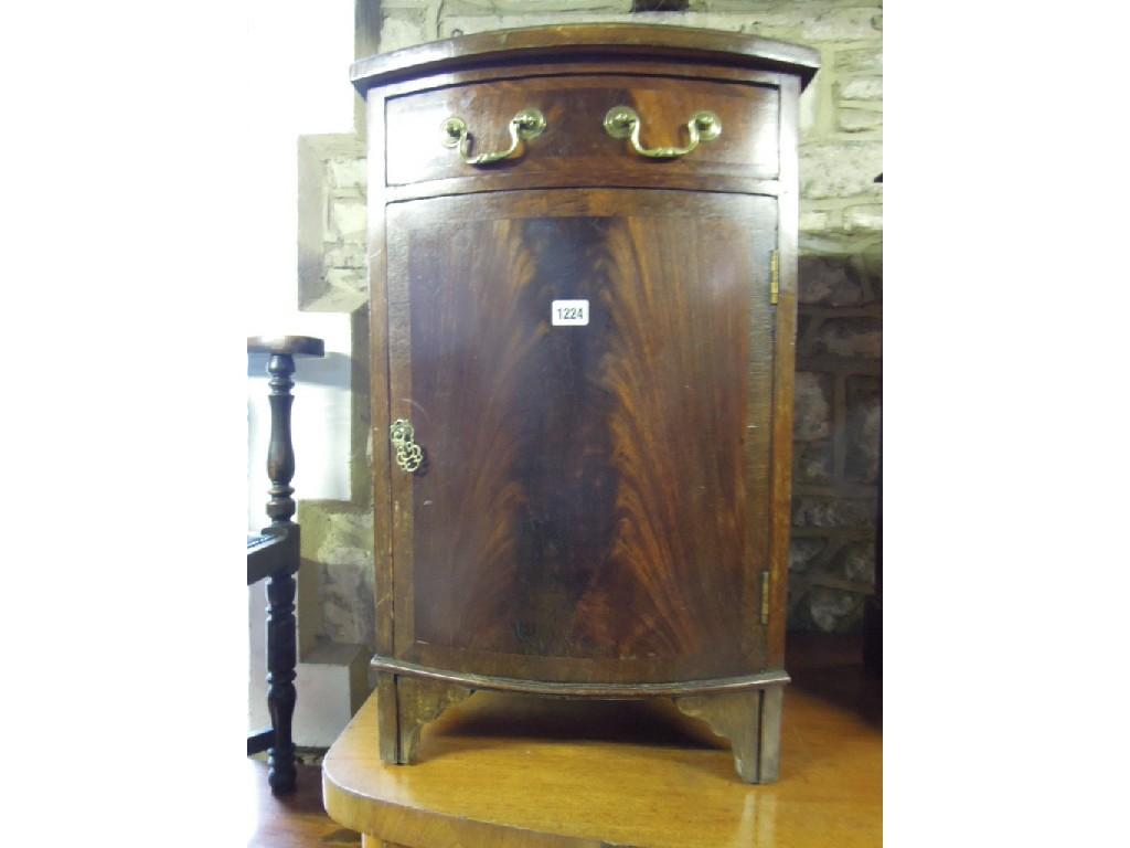 Appraisal: A bow fronted mahogany bedside cupboard in the Georgian style