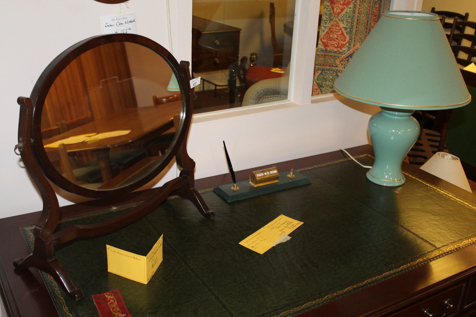 Appraisal: A mahogany finish dressing mirror the oval glass flanked by