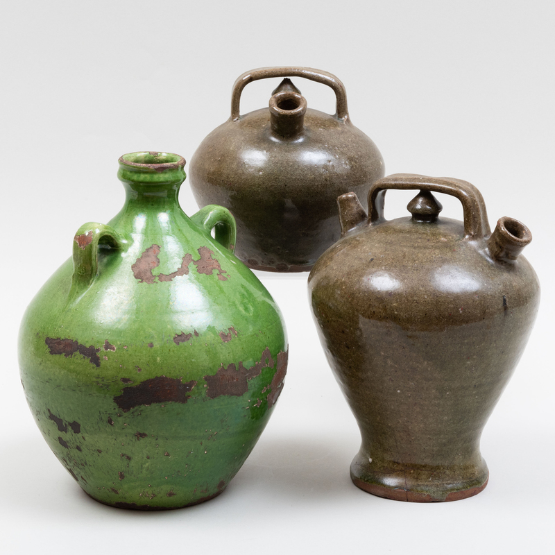 Appraisal: GROUP OF THREE GLAZED EARTHENWARE JUGS Unmarked The largest x