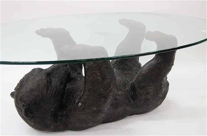 Appraisal: BRONZE BEAR COFFEE TABLE featuring a patinated bronze bear cub