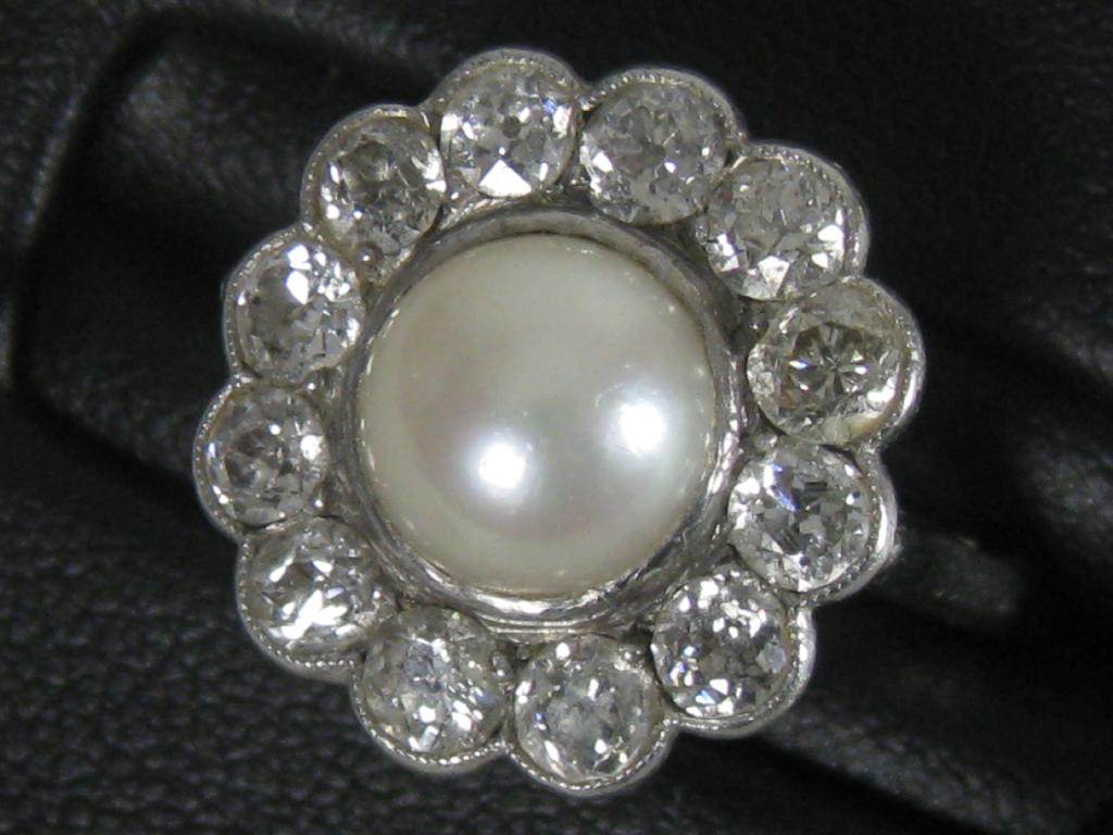 Appraisal: A Pearl and Diamond Cluster Ring the central cultured pearl