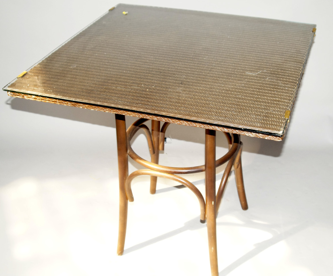 Appraisal: A Lloyd Loom square table with plate glass top cm