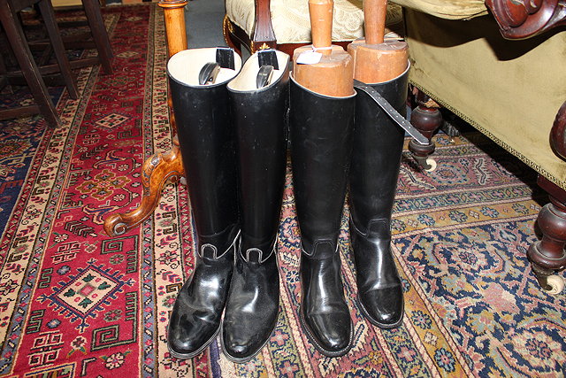 Appraisal: TWO PAIRS OF BLACK RIDING BOOTS one complete with wooden