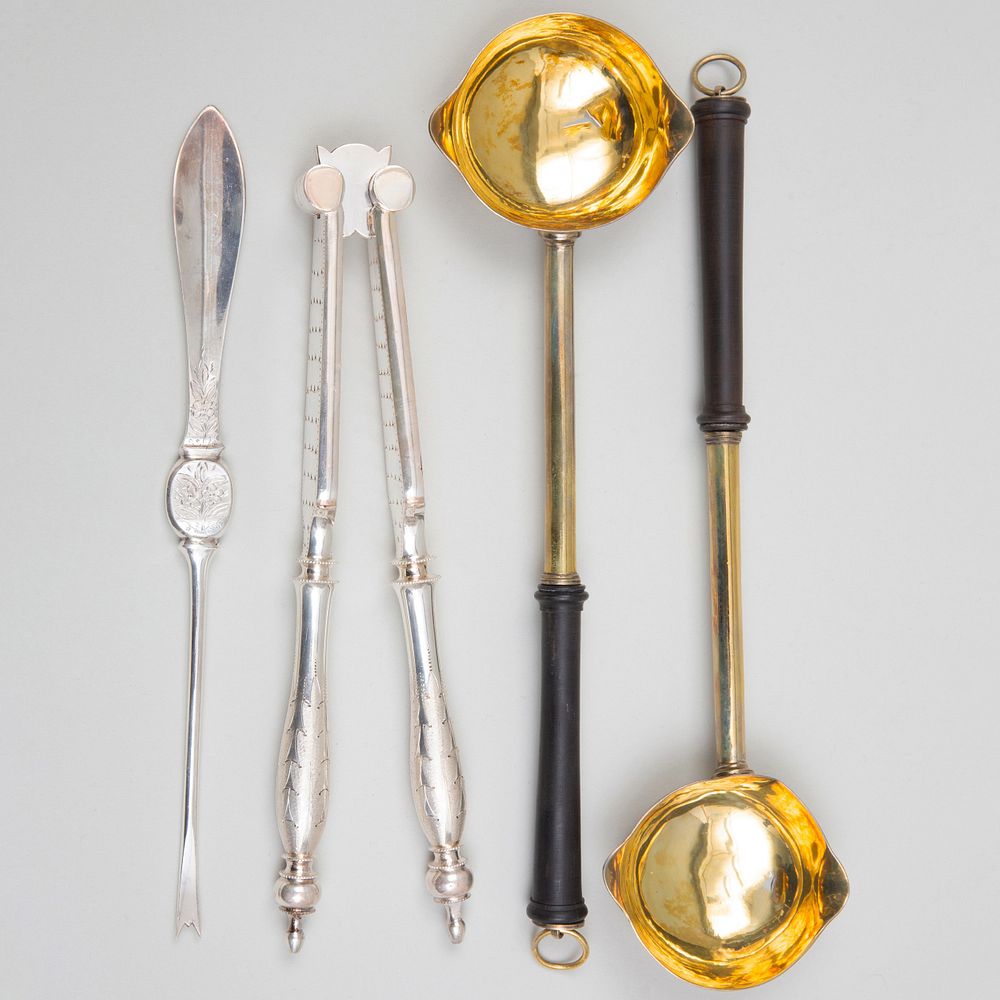 Appraisal: Pair of George III Silver-Gilt Ladles and Silver Plate Nutcracker