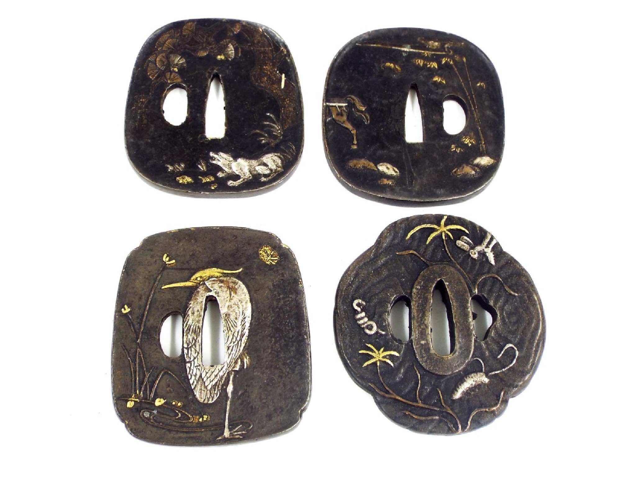 Appraisal: Four various Japanese embossed iron tsubas with silver and gilt