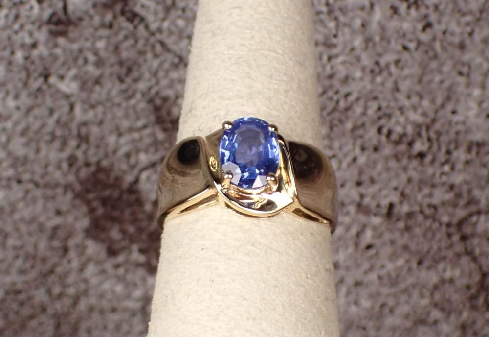 Appraisal: SAPPHIRE SOLITAIRE AND FOURTEEN KARAT GOLD RING yellow gold band