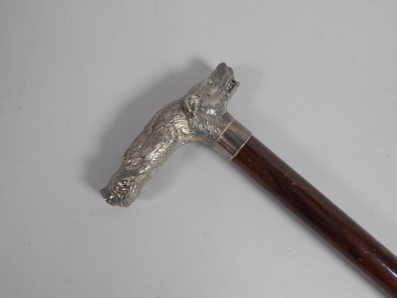 Appraisal: A Continental mahogany walking stick the handle cast with a