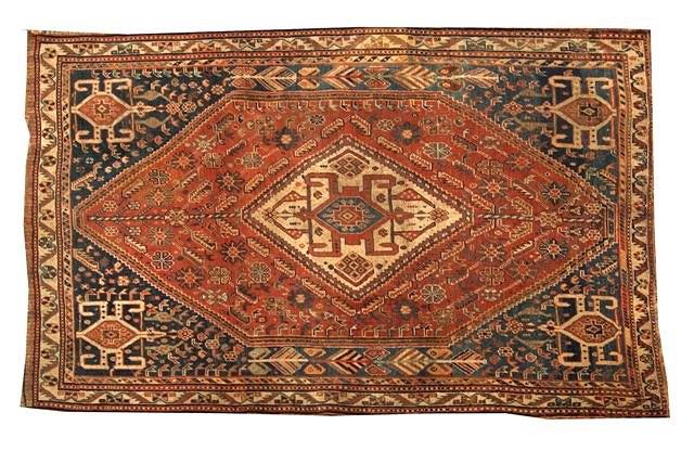 Appraisal: A CAUCASIAN RUST GROUND RUG decorated a central stylised medallion