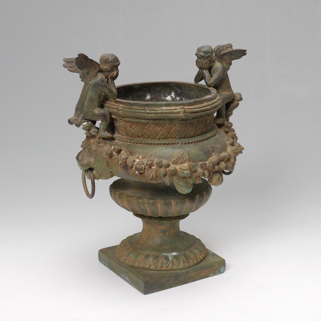 Appraisal: PATINATED BRONZE CHERUB PLANTER Bronze urn form planter with figural