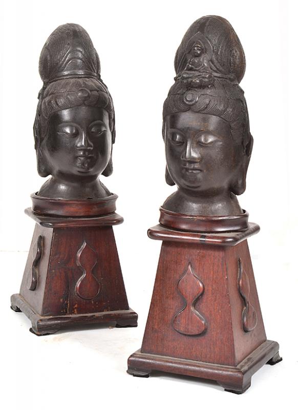 Appraisal: TWO BRONZE HEADS OF GUANYIN one wearing a petal-shaped diadem